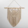 macrame wall hanging on tree branches