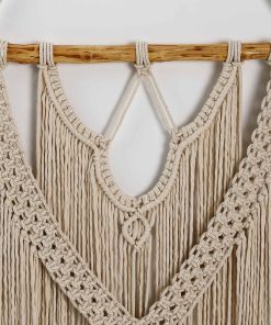 macrame wall hanging on tree branches